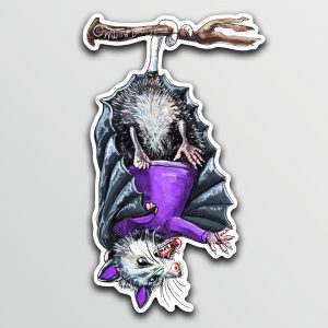 Sticker of an illustration of an opossum dressed in a bat costume hanging upside down.