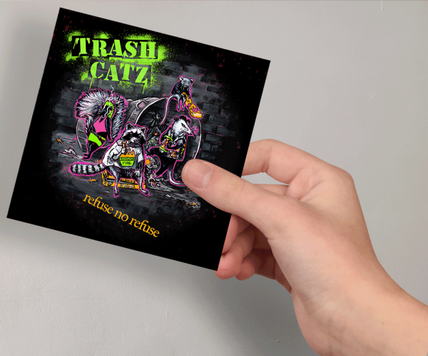 A sticker with an illustration of a punk band made up of animals in an alley surrounded by trash, with the phrase "Trash Catz Punk" above them in stenciled neon letters with the phrase "Refuse No Refuse" below them styled like an album cover. The sticker is in a hand.