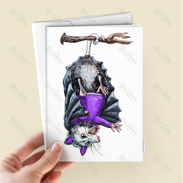 Opossum hanging upside down in a purple and black bat vampire costume. It's a possum, possums, 'possum. However you spell it.