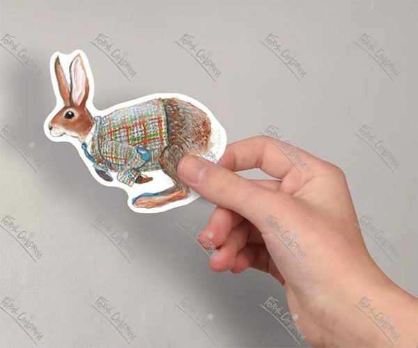 A sticker of an illustration of a handsome hare wearing a smart tweed jacket with elbow patches, a white collared shirt and a blue tie.