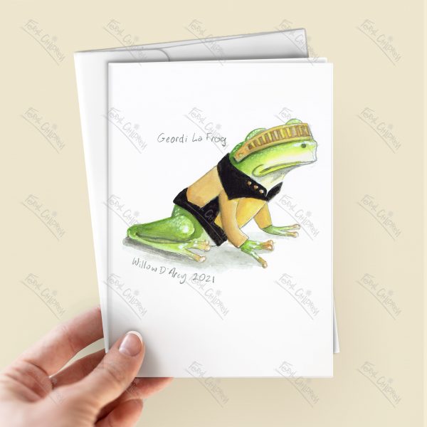 Geordi La Frog - greeting card in a hand with the illustration of a frog dressed in a yellow engineer's shirt and visor from the iconic star exploration tv series